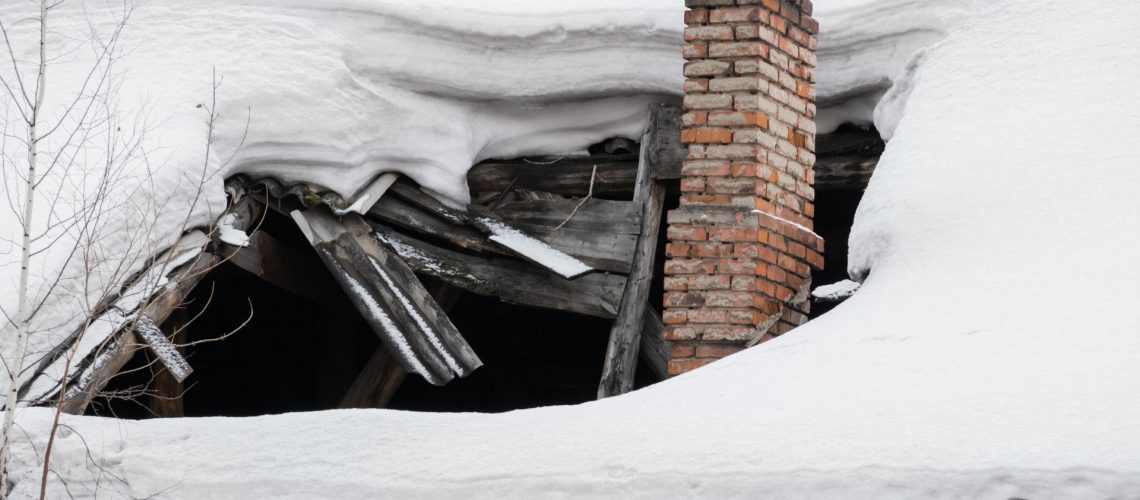 The roof collapsed under the weight of snow. Damaged falling roo